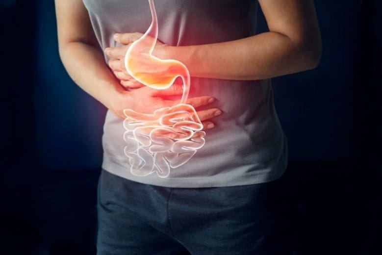 Picture6 | roma hospital Person holding their stomach with a glowing digestive system overlay, indicating abdominal pain or cramps.